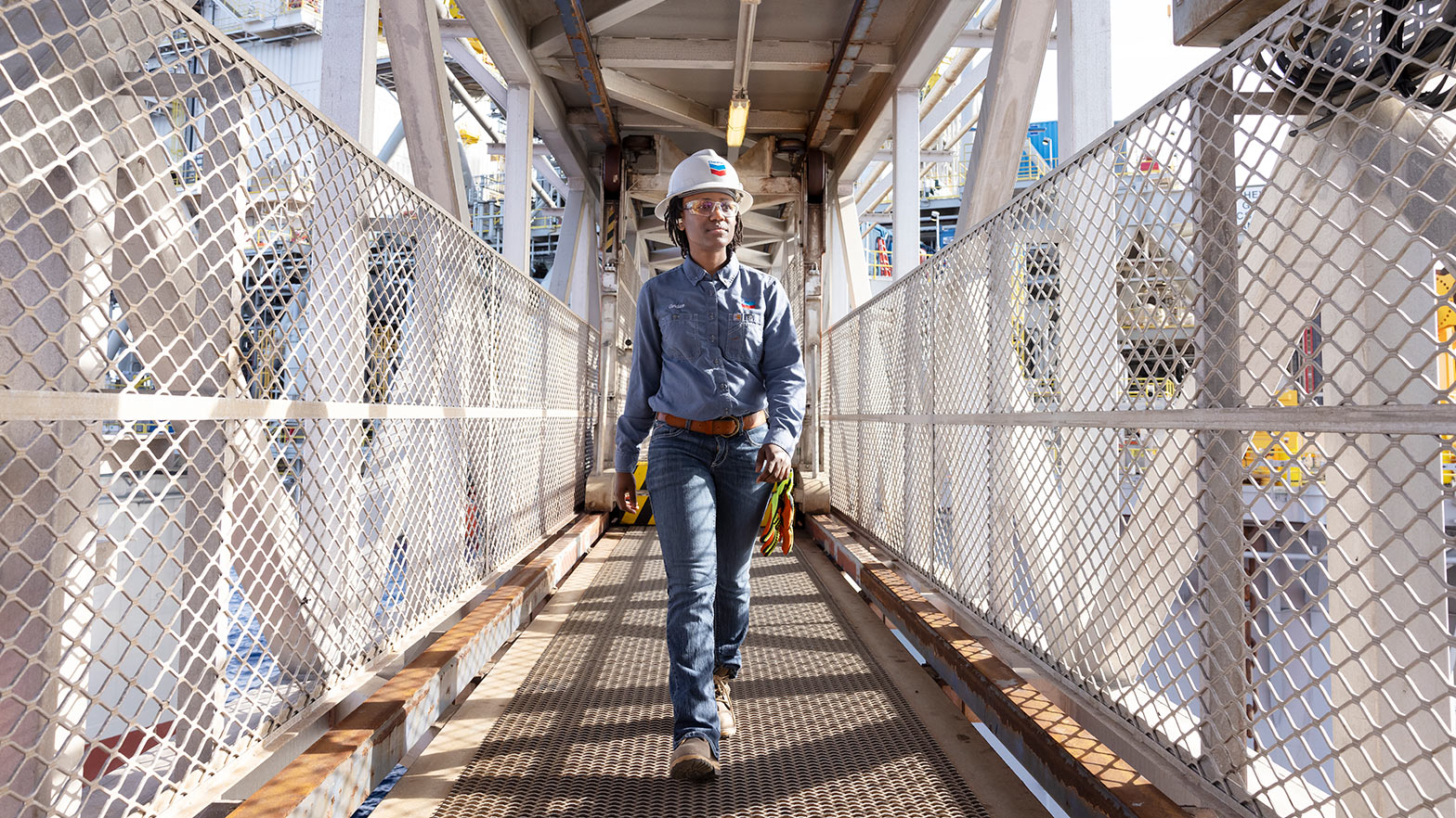 Worker walking down platform aisle